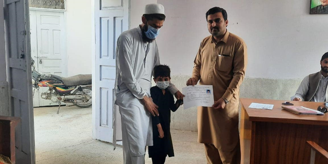 A child with a disability receives his disability certificate.
