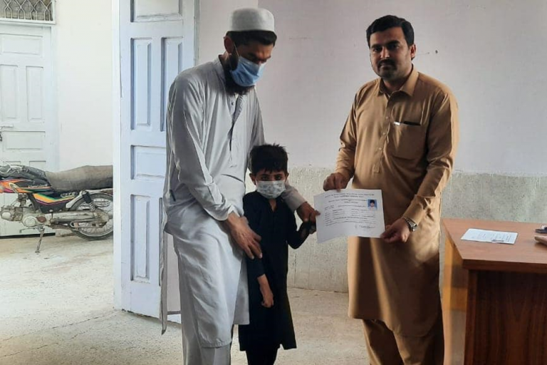 A child with a disability receives his disability certificate.